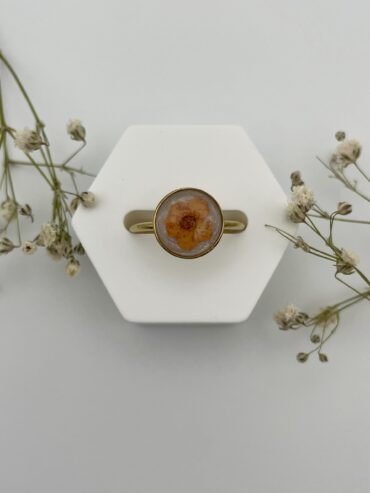 Anillo redondo blanco con flor naranja