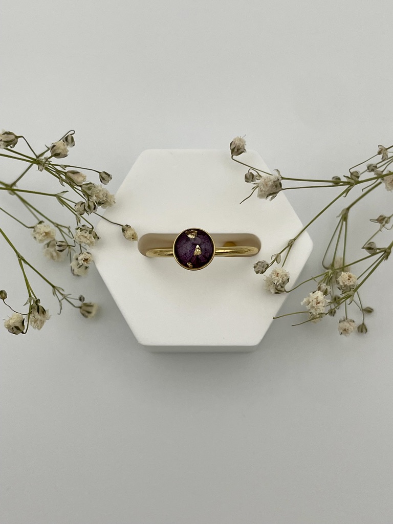 Anillo redondo con pétalos de flor morada oscura