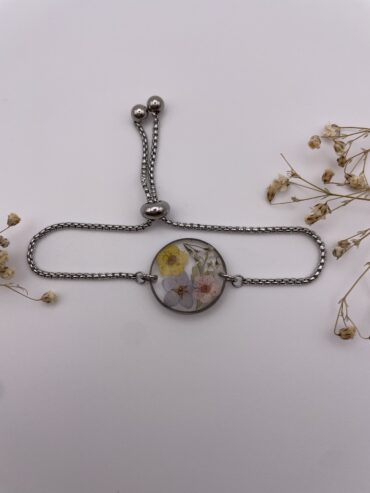 Pulsera redonda con flores amarilla, azul y rosa claro